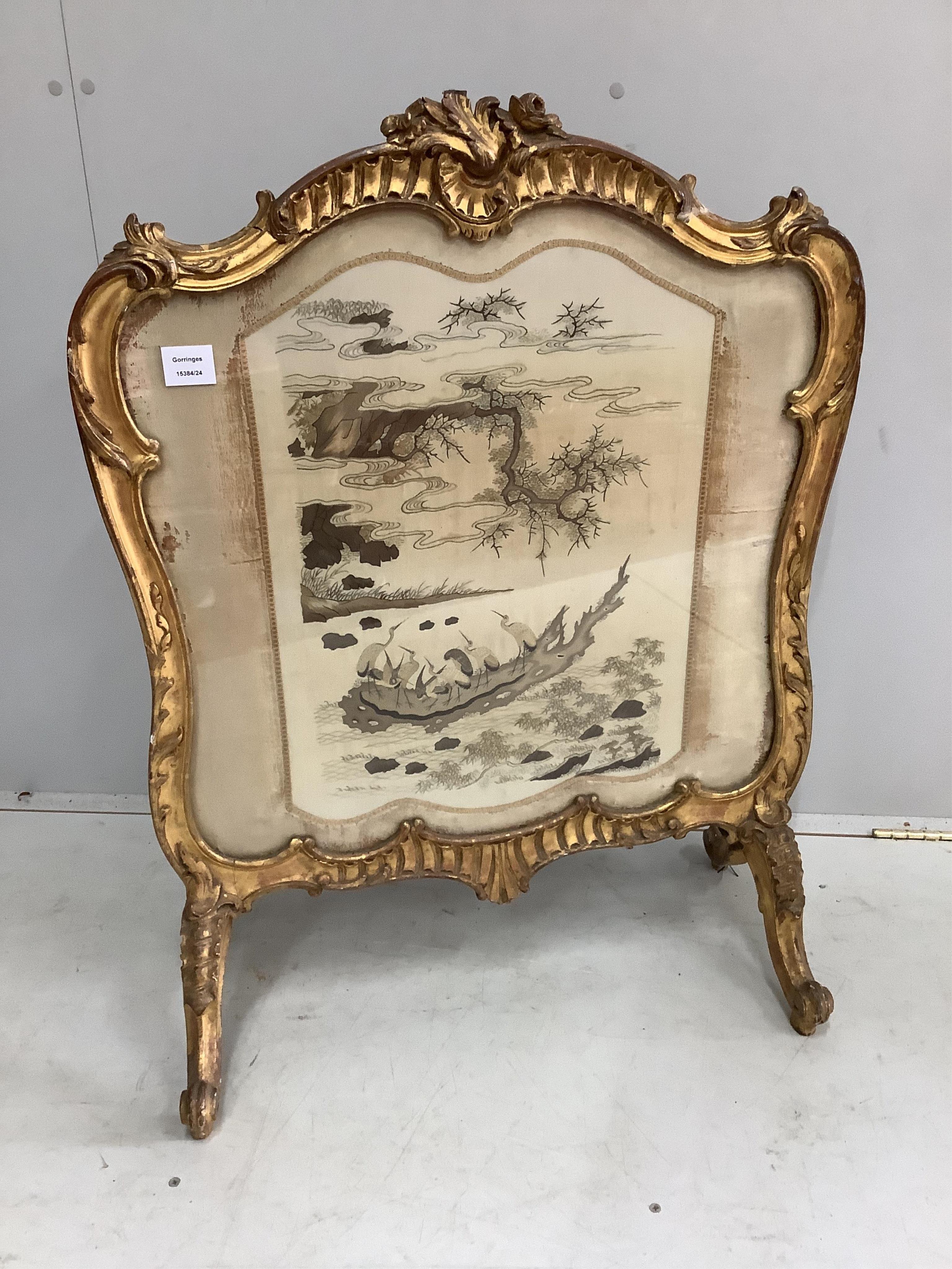 A Victorian giltwood and composition firescreen, inset silk thread embroidered panel, width 69cm, height 90cm. Condition - fair